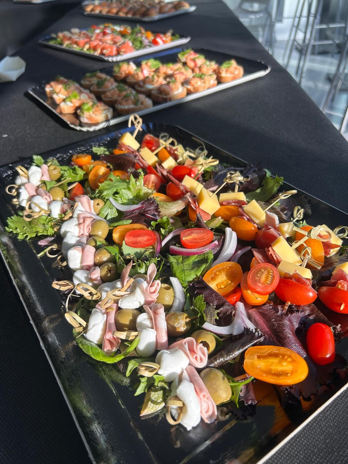 Plateaux de canapés et brochettes dressés sur une table de réception